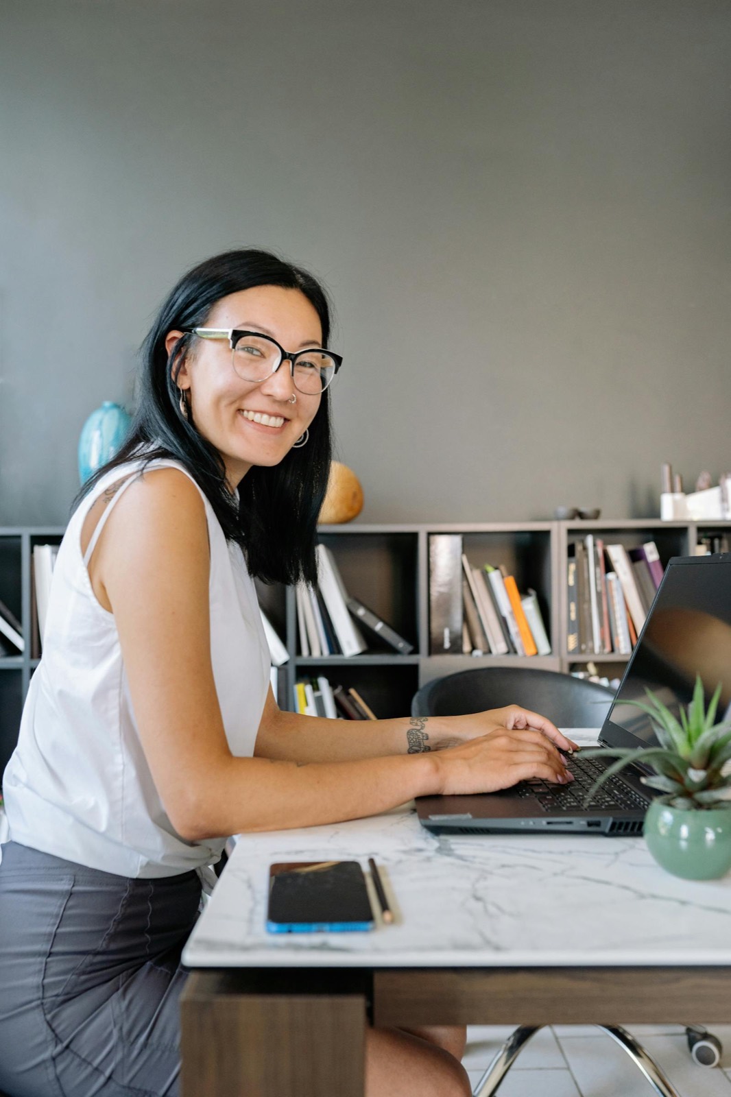 A care-agency scheduler at her desk, unhurried, while Avover handles the morning's call-out.